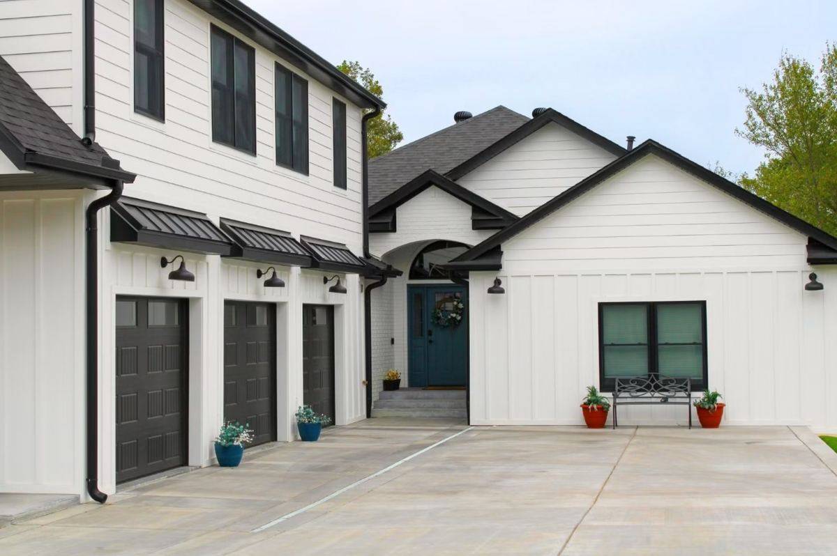 Modern farmhouse exterior with black metal roof accents and new siding