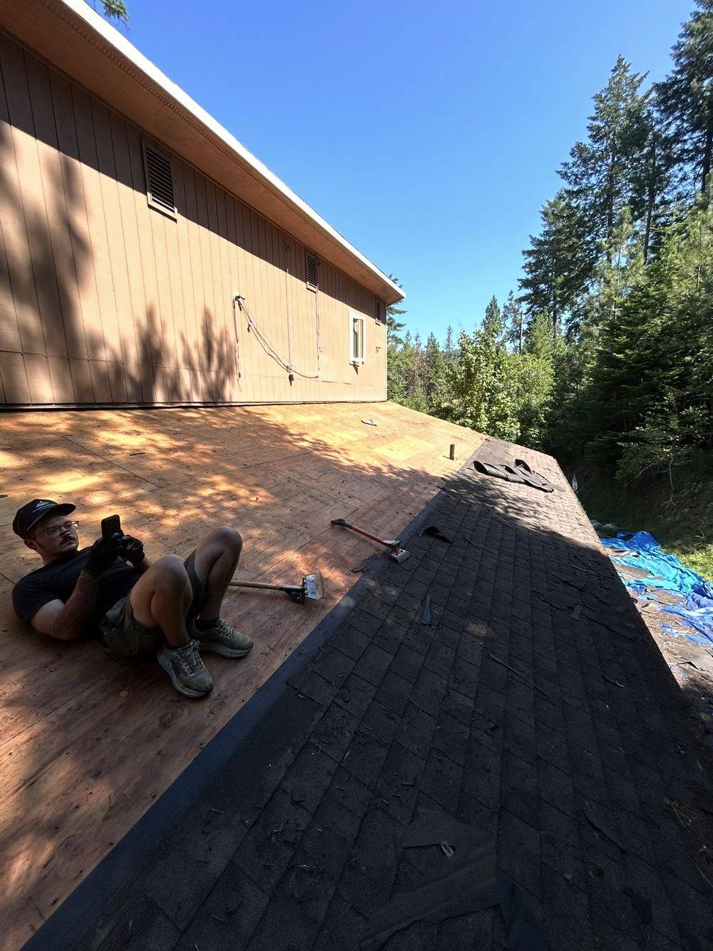 Roofer installing architectural asphalt shingles on a home in Coeur d'Alene
